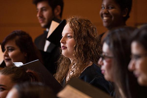 Choir members on stage during a performance